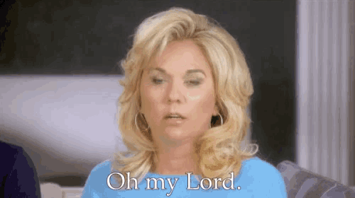 a woman is sitting on a couch and saying oh my lord .