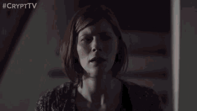 a woman is sitting on a set of stairs with her eyes closed and a crypt tv logo in the corner .