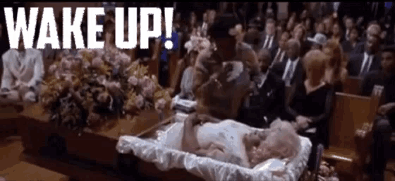 a woman is laying in a coffin with the words wake up written above her