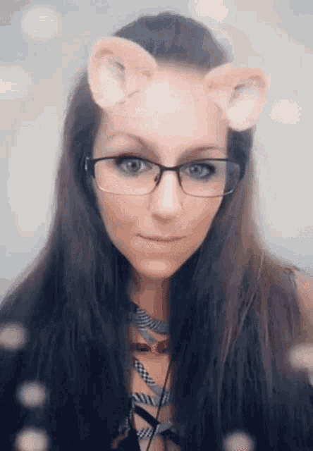 a woman with glasses and cat ears on her face .