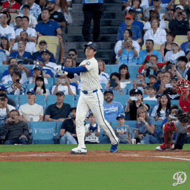 a dodgers baseball player swings at a pitch