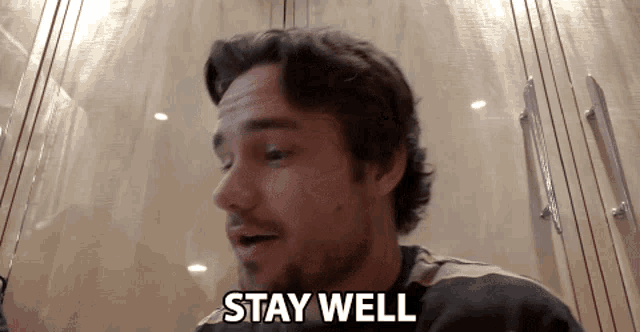 a man says " stay well " in front of a closet