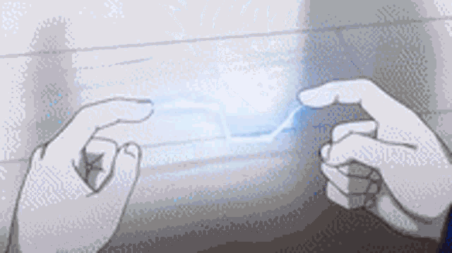 a person 's hands are holding a blue lightning bolt between them .