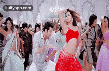 a man and a woman are dancing in a crowd of people .