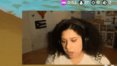a woman wearing headphones is sitting in front of a computer screen with a time of 0:53