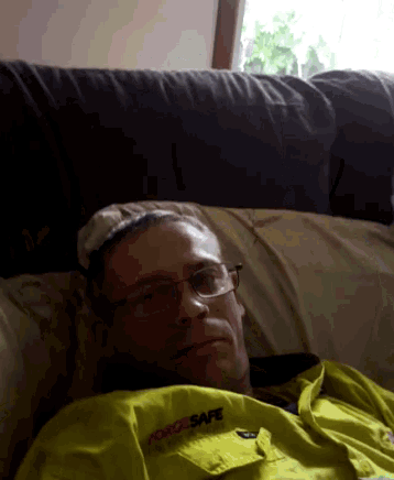 a man is laying on a couch wearing a yellow shirt that says rescuesafe