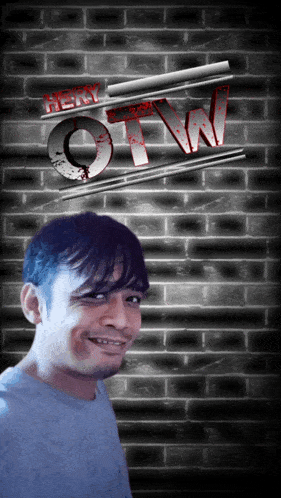 a man stands in front of a brick wall with the word otw on it
