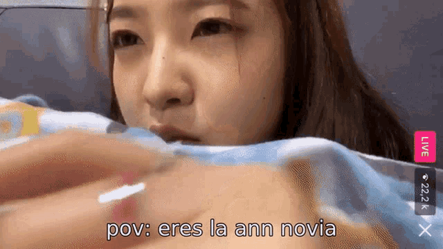 a woman is laying on a couch with the words " pov eres la ann novia " on the bottom