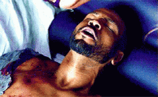 a man with a beard is laying down with his mouth open