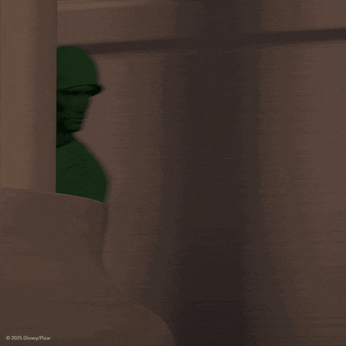 a green toy soldier from disney pixar is pointing his gun