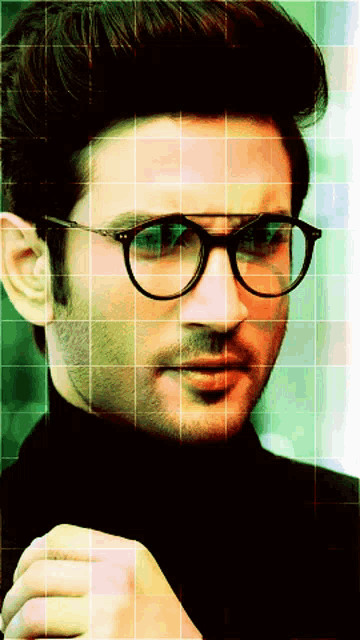 a man wearing glasses and a black turtleneck looks to the side