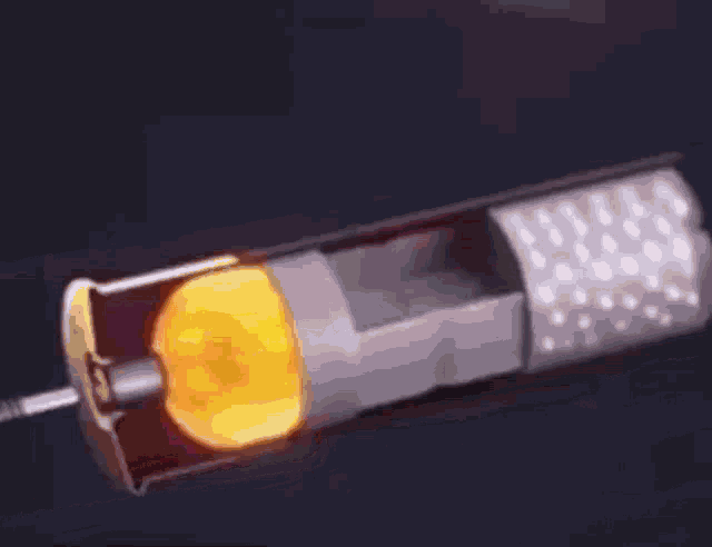 a close up of a cigarette with flames coming out of it on a black background .