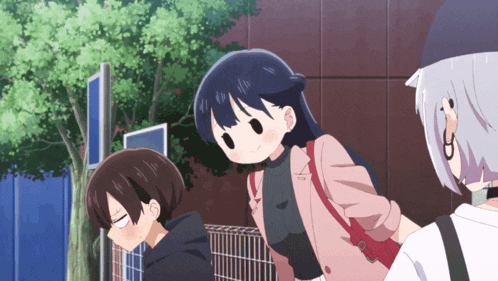 a girl in a pink jacket stands next to a boy