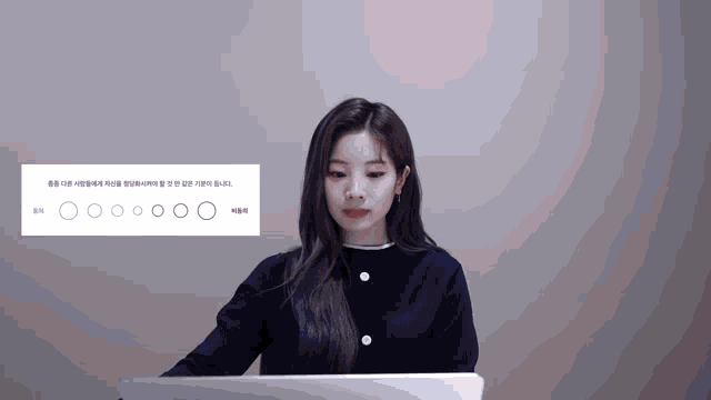 a woman sitting in front of a laptop with circles on the screen that says ' o ' on it
