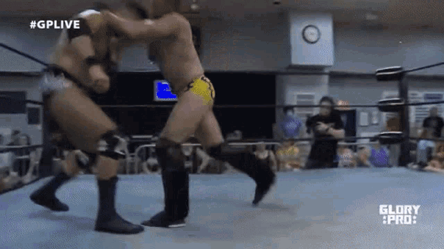 two wrestlers are fighting in a ring with the words glory pro on the bottom