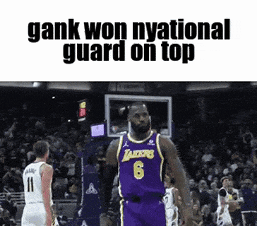 a basketball player wearing a purple lakers jersey stands on top of a basketball court .