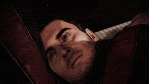 a close up of a man 's face with a shocked look on his face