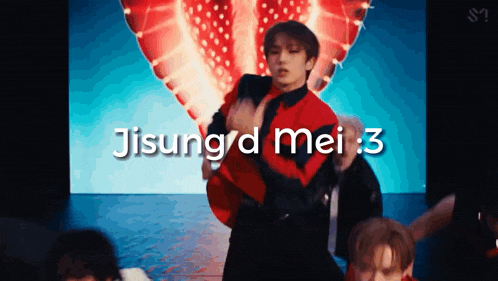 a man in a red jacket is dancing in front of a screen that says jisung 'd mei : 3