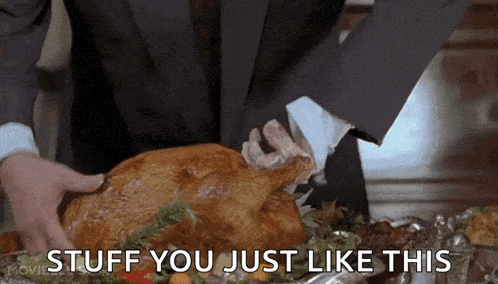 a man in a suit is holding a roasted turkey with the words stuff you just like this above it