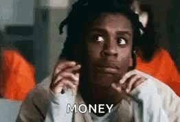 a man with dreadlocks is talking on a cell phone in a jail cell and says `` money '' .