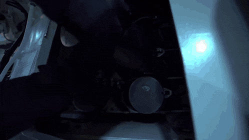 a dark room with a blue light shining through the ceiling