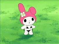 a pink and white bunny is standing in the grass holding a penguin .