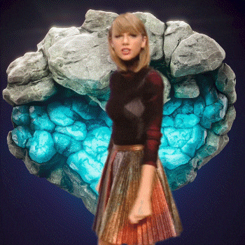 a woman in a pleated skirt stands in front of a rock
