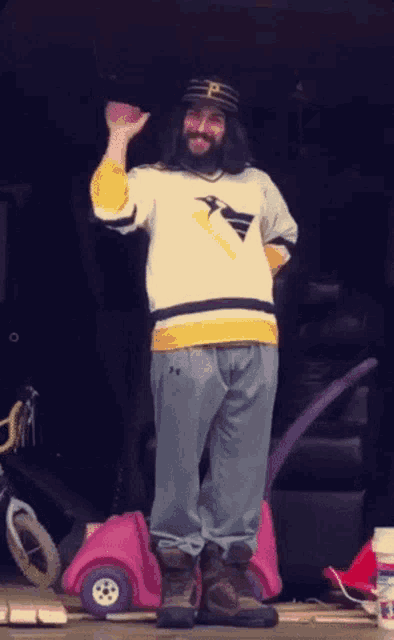 a man with long hair and a beard wearing a pittsburgh jersey
