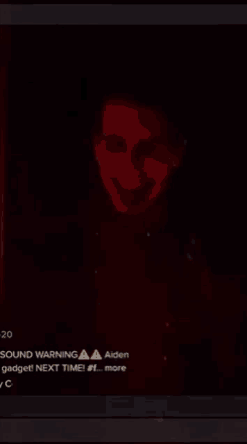 a picture of a man in a dark room with a warning sign on it