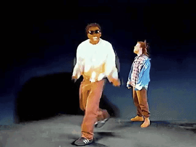 a man and a girl are dancing on a stage .