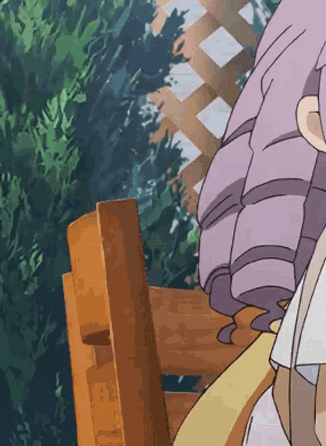 a girl with purple hair is sitting on a bench