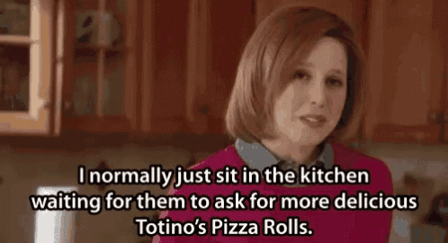 a woman is sitting in the kitchen waiting for someone to ask for more delicious totino 's pizza rolls
