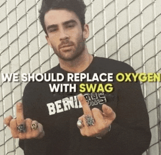 a man with rings on his fingers is wearing a shirt that says we should replace oxygen with swag