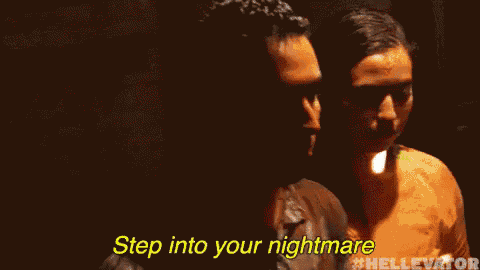 a man is standing in a dark room with the words `` step into your nightmare '' written above him .