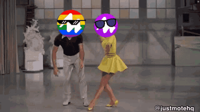 a man and a woman are dancing on a dance floor with their heads on rainbow colored balls