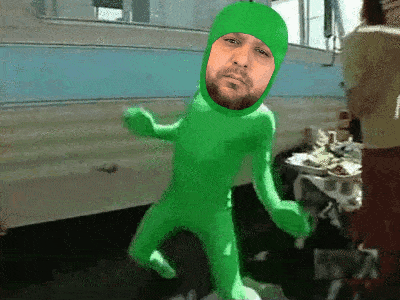 a man with a beard is wearing a green suit with a face on it