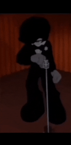 a cartoon character is standing in front of a microphone .