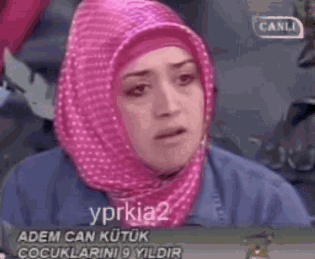 a woman wearing a pink hijab is crying and the words lapezementk are above her