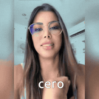 a woman wearing glasses has the word cero written on her hand