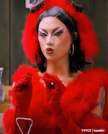 a woman in a red devil costume is wearing red gloves and a red hat