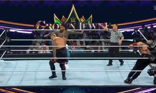 a wrestling match is going on in a ring with a crown jewel logo in the background