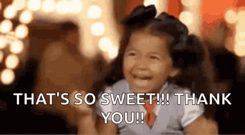 a little girl is laughing and saying `` that 's so sweet ! thank you ! ''