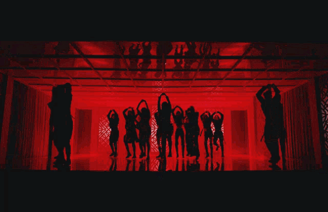 a group of people are dancing on a stage