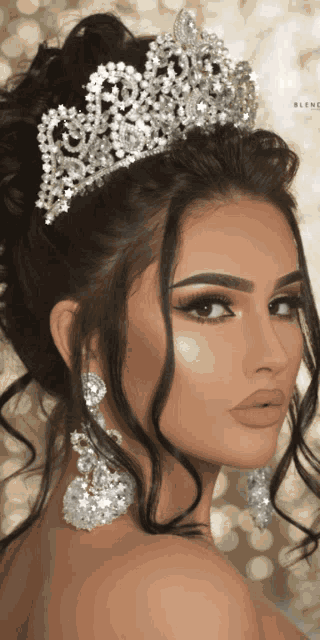 a woman wearing a tiara and earrings looks like a princess