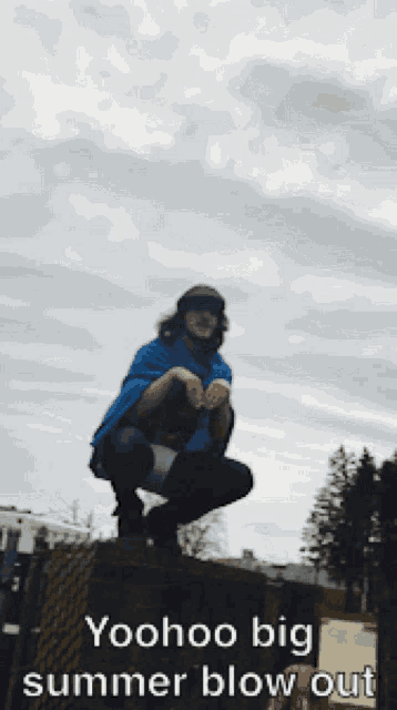 a man squatting on top of a box with the words yoohoo big summer blow out