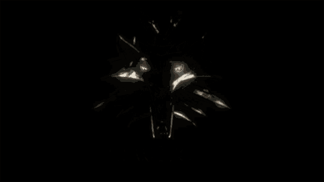a silver pendant with a wolf head on it