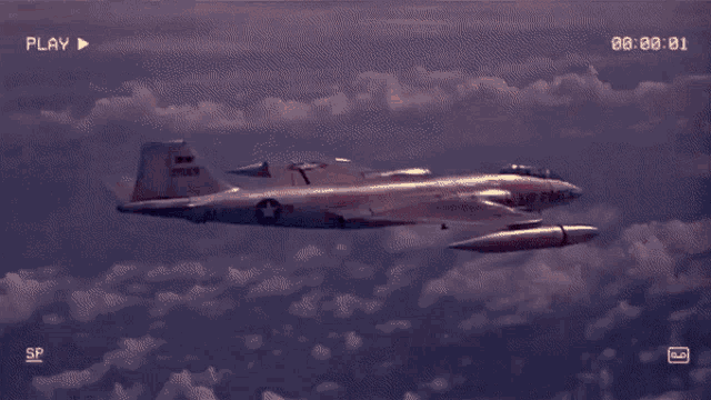 a video of a fighter jet flying in the sky with the play button visible
