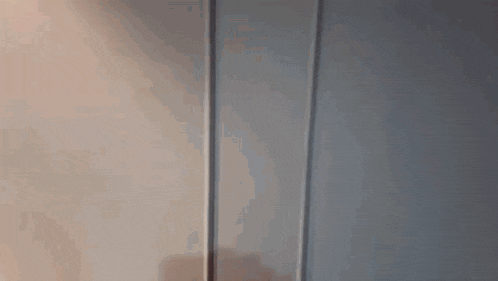 a blurry picture of a woman 's face with earbuds in her ears .