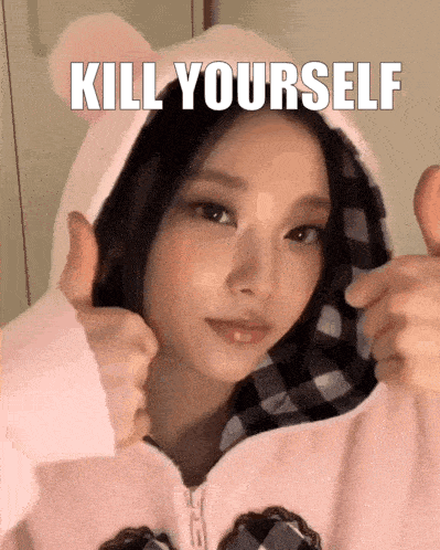 a girl wearing a hoodie with the words kill yourself written above her