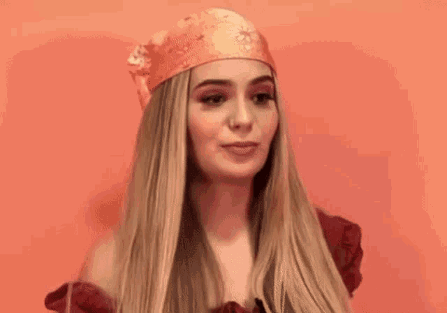 a woman wearing a bandana on her head is making a face .